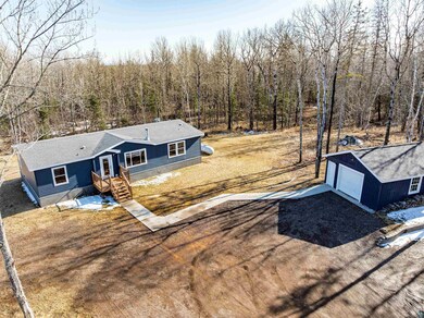 Aerial view featuring a view of trees & a sprawlin