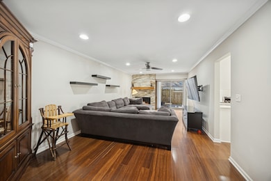 Sliding doors lead to covered brick paver patio