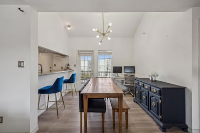 Dining area with light wood-type flooring, lofted 