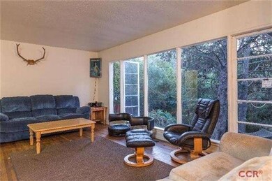 Living Room with Picture Windows to large backyard