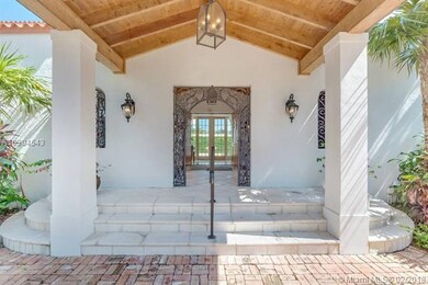 Porte cochere and iron gate as you enter