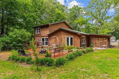 Back of property featuring a fire pit and french doors