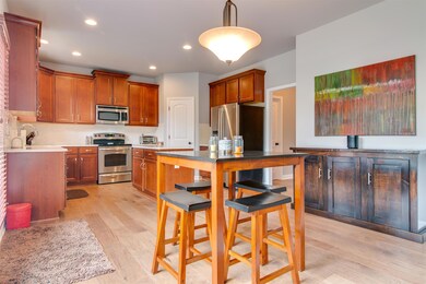 Living room is open to the kitchen with dining area.  New wood floor and stainless steel appliances