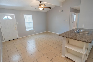 Foyer featuring light tile patterned flooring and ceiling fan