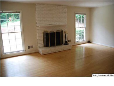 Family room with brick fireplace, hardwoods and bu