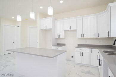 Kitchen featuring a center island, white cabinetry