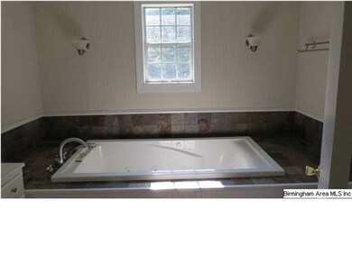 Master bathroom features large jetted garden tub w
