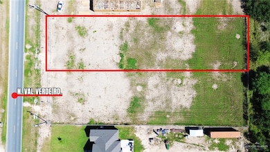 Aerial view of sparsely populated area with property parcel outlined
