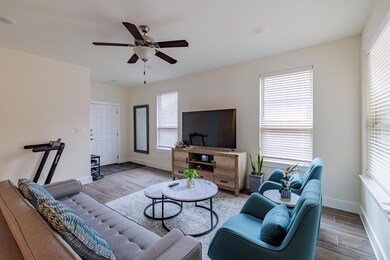 Living area featuring wood finished floors, a cei