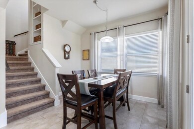 Dining room with light tile patterned floors, sta