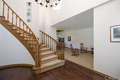 HARDWOOD ENTRY WITH SWEEPING STAIRCASE