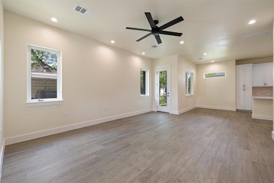 Unfurnished living room with visible vents, reces