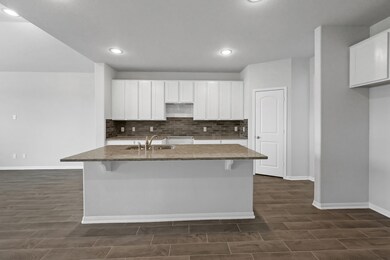 This kitchen is by far any chef’s dream. This spacious kitchen features high ceilings, white stained wood cabinets, granite countertops, SS appliances, modern tile backsplash, recessed lighting, extended counter space, granite kitchen island with double sink and space for breakfast bar, and a walk-in pantry all overlooking your huge family room.