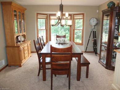 Dining room with bay window is open to the great r