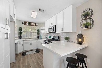Updated kitchen with high quality cabinets, quartz countertops, and a breakfast bar.
