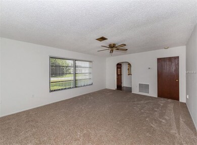 Large living room with fresh paint and new carpet.