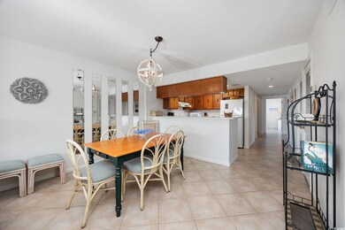 Dining room with a chandelier and light tile patterned floors