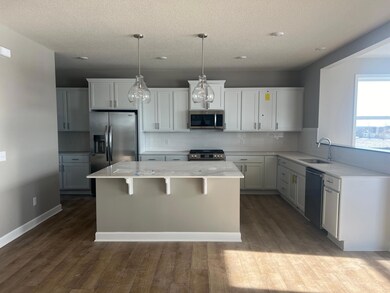 Stunning cabinets help bring this home's kitchen to life. Features include stainless appliances, a spacious walk-in pantry, granite counters and a ceramic backsplash that ties the kitchen together. Actual interior of the home!