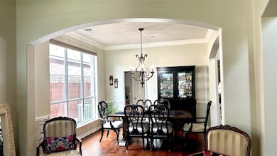 Dining room featuring wood finished floors, crown