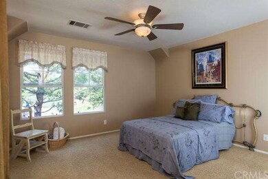 The Master Bedroom overlooks the tree lined view.