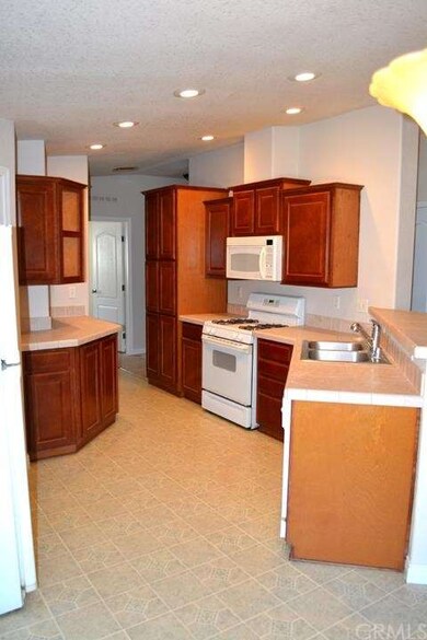 Linoleum on kitchen floor, and tiles counter tops.