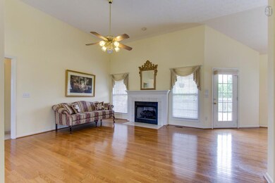 UNIQUE FIREPLACE WITH A WHITE MANTLE AND A DOOR THAT LEADS TO THE BACK DECK