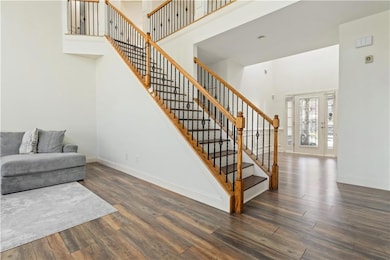 Staircase featuring wood finished floors