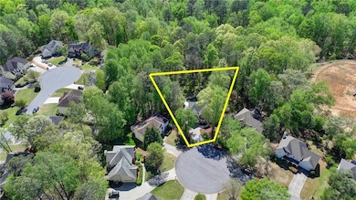 Birds eye view of property with a wooded view and 
