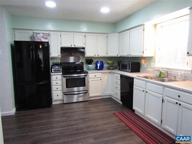 Spacious kitchen with white cabinets, new flooring