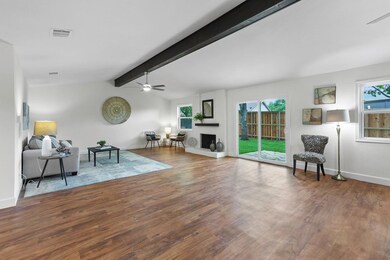 Living room featuring ceiling fan, wood finished 