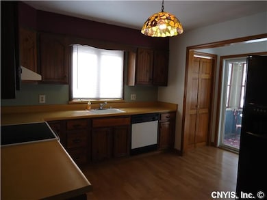Kitchen. Entry to enclosed back porch as well as t