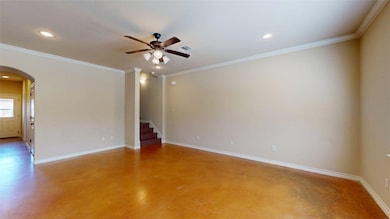 Spare room with crown molding, arched walkways, ceiling fan, recessed lighting, and finished concrete floors