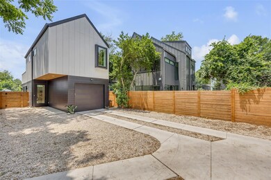 View of side of home with concrete driveway, an a