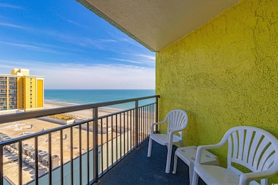 Balcony with a water view and a view of the beach