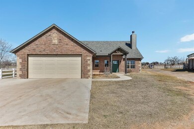 View of front of house featuring driveway, a chimn
