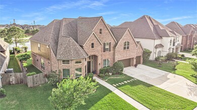 Lovely brick elevation with meticulous landscaping and a 3-car garage.