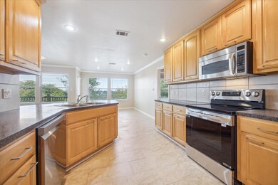 Kitchen featuring stainless steel appliances, a s
