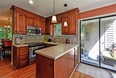 Kitchen showing dining room with sliding door to deck and outside storage