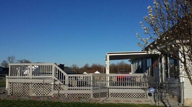 LARGE WOODEN DECK SURROUNDS THE ABOVE GROUND POOL. COVERED DECK FOR SHADE AND GREAT SPACE FOR COOKOUTS AND ENTERTAINING YOUR FAMILY AND FRIENDS. 