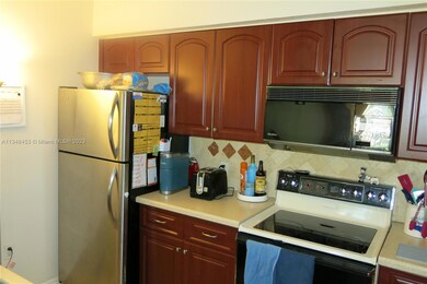 Kitchen with stainless fridge and smooth cooktop
