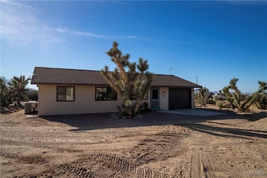 Ranch-style house with a garage and central AC
