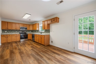 The kitchen offers stainless steel appliances, LVP