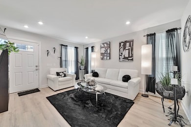 Living area featuring light wood-style flooring an