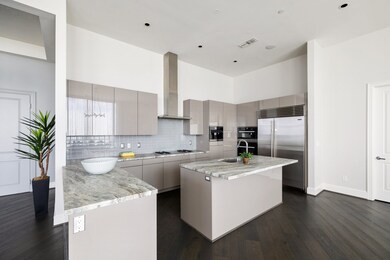 The sleek chef's kitchen offers Miele appliances,