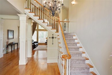 Wood floors extend into den and dining area.