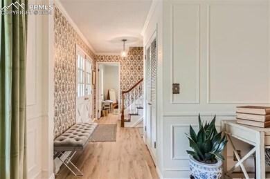 Corridor featuring ornamental molding and light ha