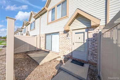 Doorway to property with a residential view and brick siding