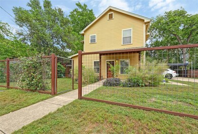 View of front of home with fence, a vegetable gar