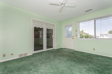 Spare room with carpet floors and ceiling fan