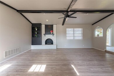 Unfurnished living room with beam ceiling, light h